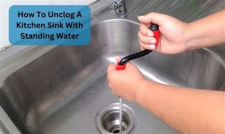 How do I unclog a drain with standing water?