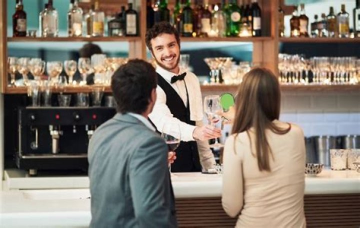 How should a bartender greet customers?